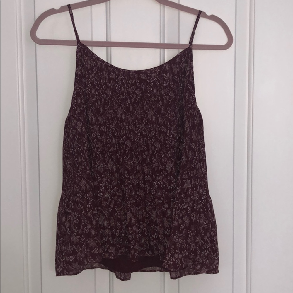 Red/maroon tank top with white floral design